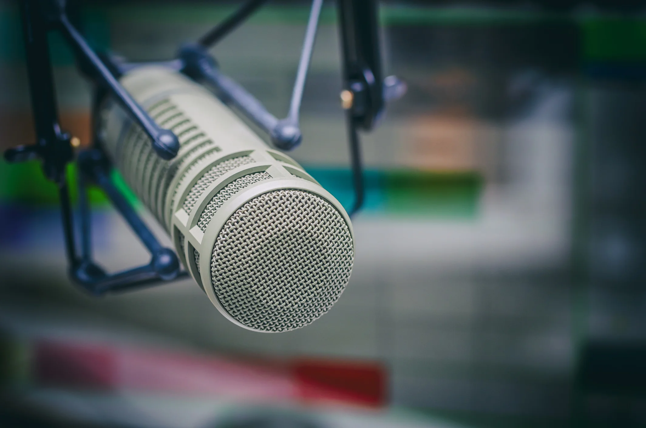 A professional broadcast microphone in a radio studio, photographed close up